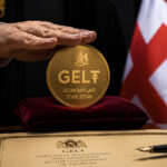 GEL₮ Georgian lari stablecoin displayed with official ceremony setting and Georgian flag symbolizing Tether-backed national payment rail expansion in Georgia